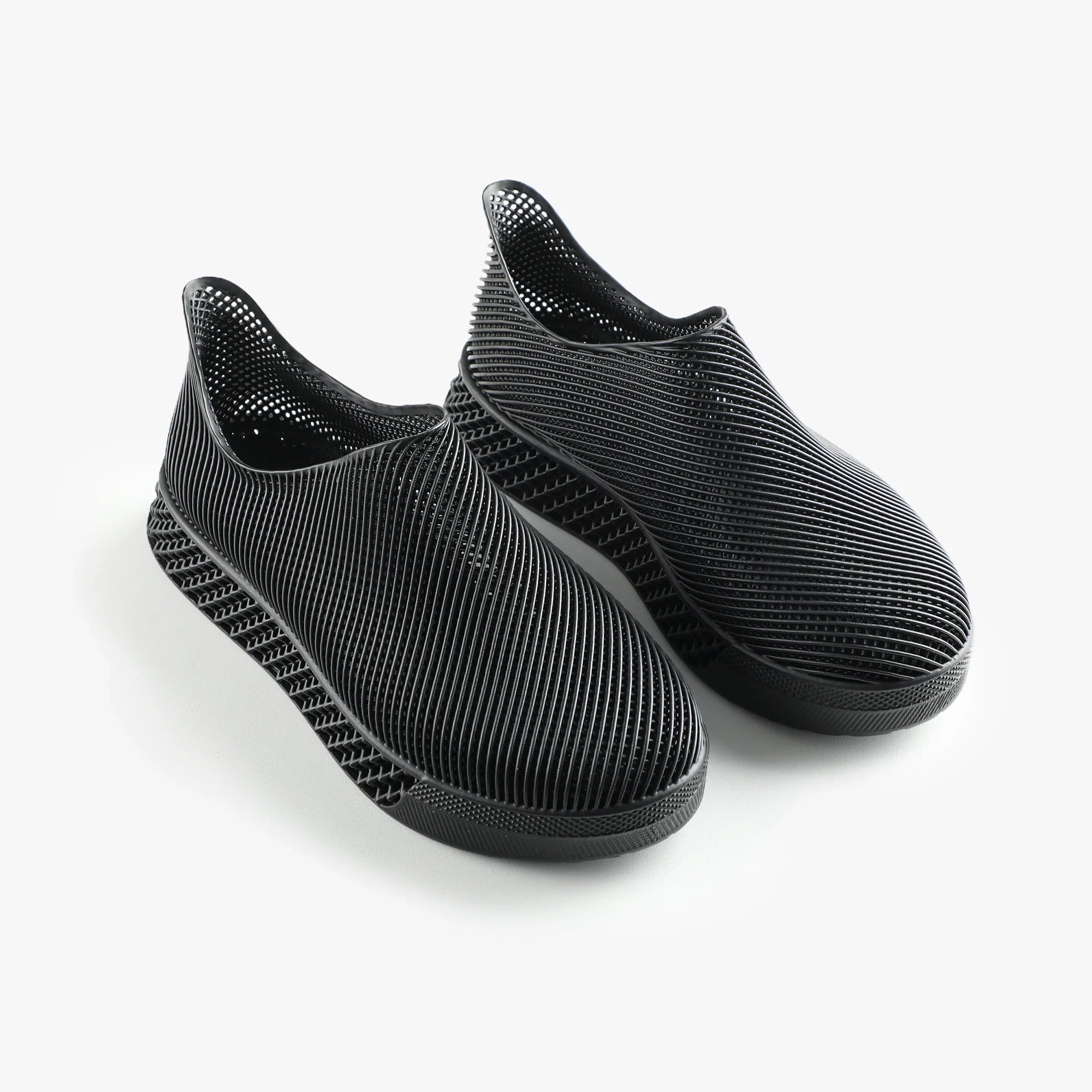 3D printed slip-on sneakers, dark black pair with ribbed knit texture