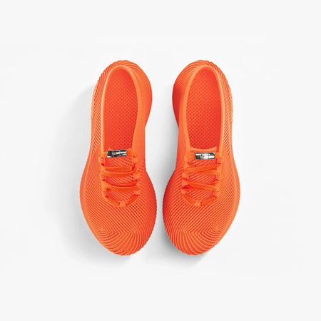 Orange 3D printed sneakers showing heel and lace-up strap detail