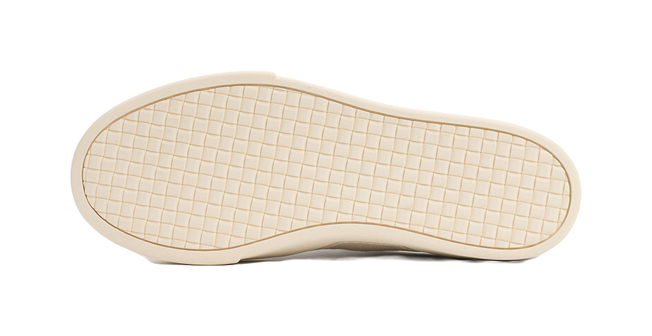 Antique white low-top skate shoe outsole with grid tread pattern