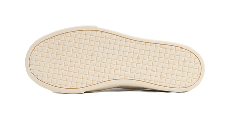 Antique white low-top skate shoe outsole with grid tread pattern