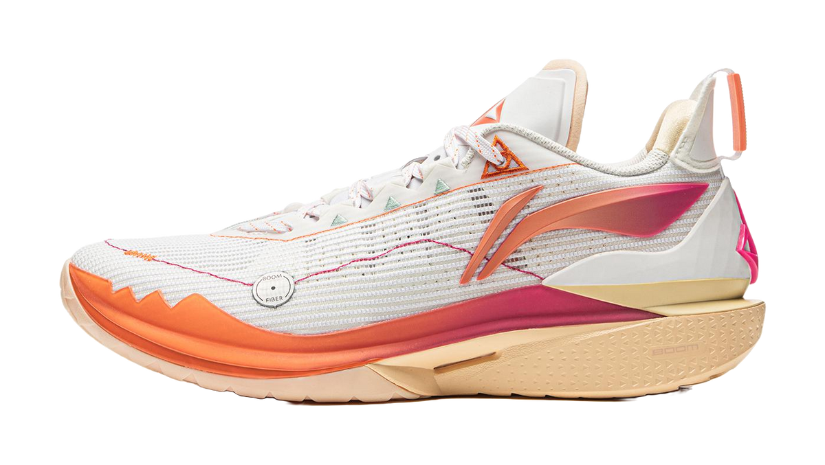 White basketball shoe with orange trim, mesh upper, and beige outsole