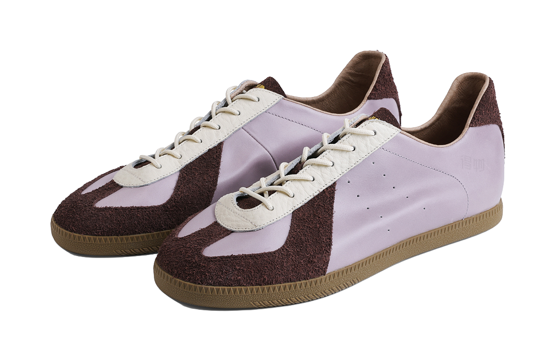 Pair of lavender low-top shoes with white laces and dark brown suede accents, gum sole