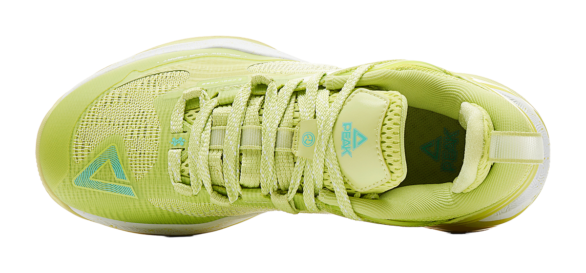 Light acid green basketball shoe showing tongue and laces with padded collar and logo