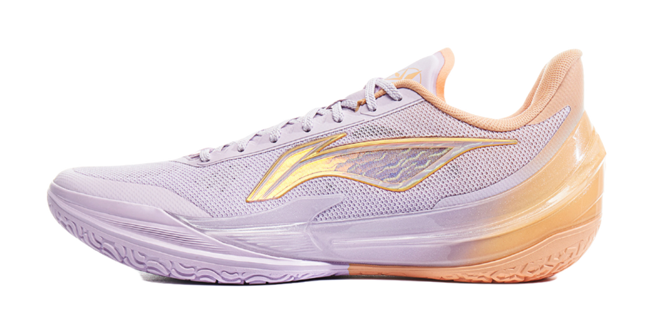 Lavender basketball shoe with orange outsole and gold logo detail.