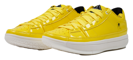 Pair of yellow lace-up basketball shoes with white midsoles and stitched panels