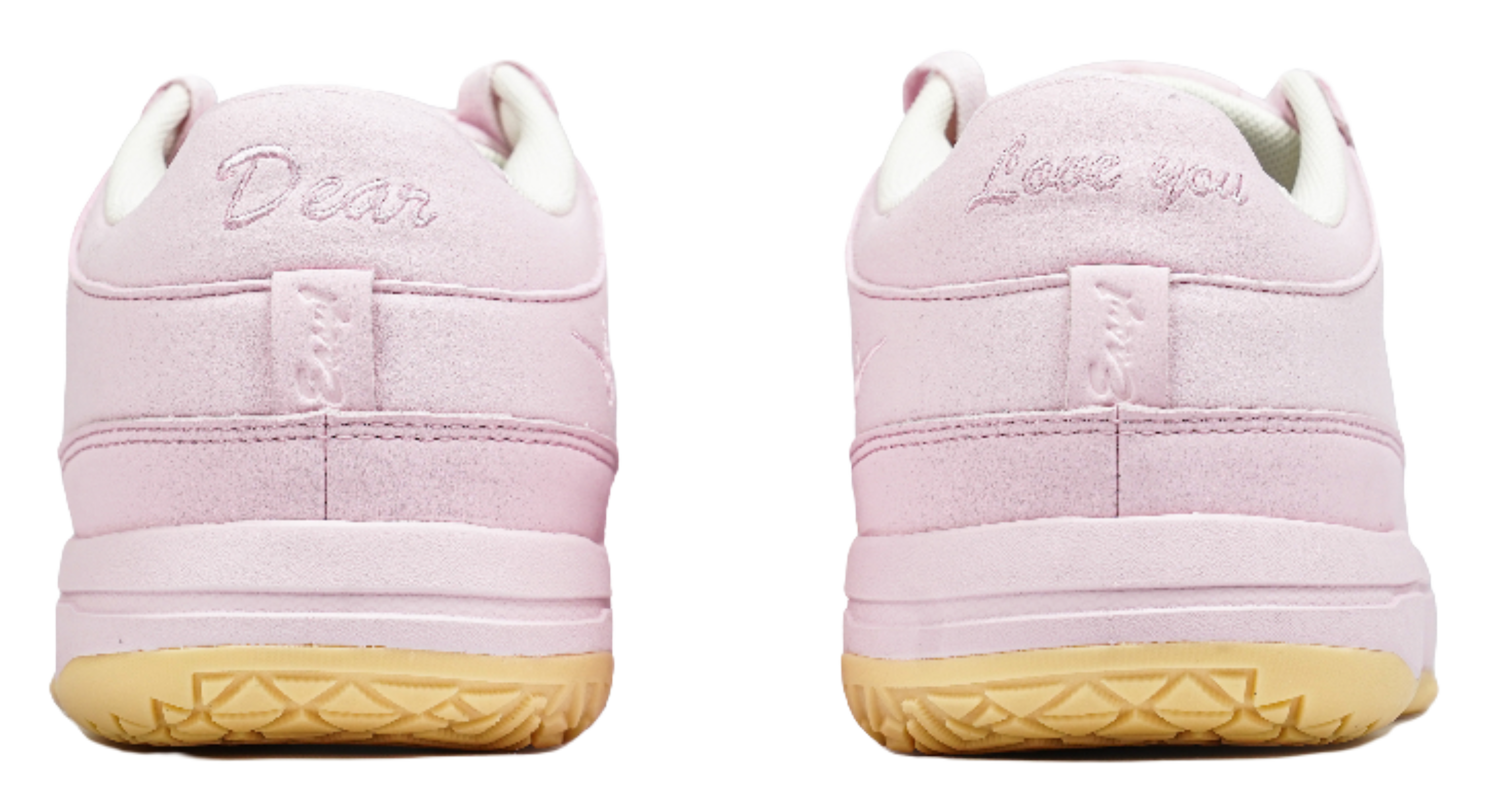 Pink low-top sneakers with rear heel branding and cushioned collar