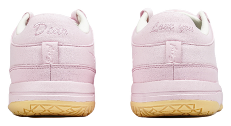 Pink low-top sneakers with rear heel branding and cushioned collar