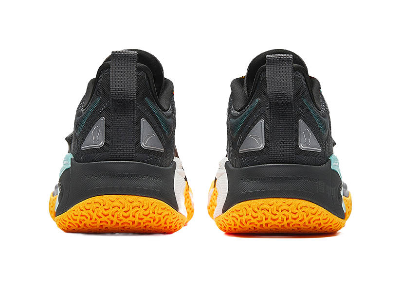 Pair of black basketball shoes with teal heel trim and orange textured outsole