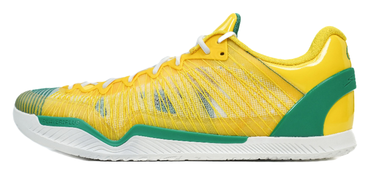 Yellow basketball shoe with green side panel, white laces, and textured sole