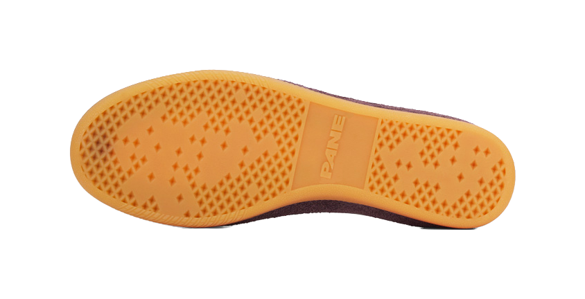 Training shoe outsole, orange gum rubber tread with PANE branding on heel area.