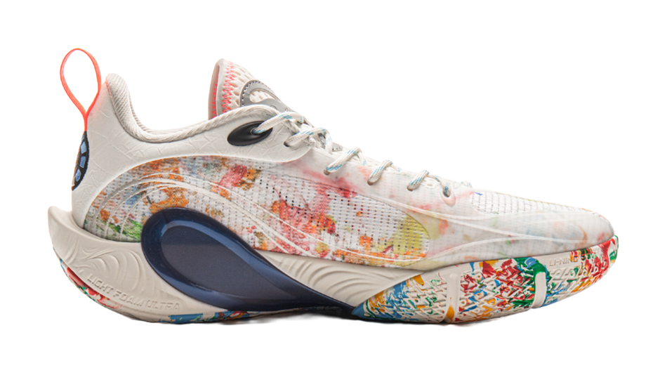 White basketball shoe side profile with multicolor graphic knit and navy heel guard