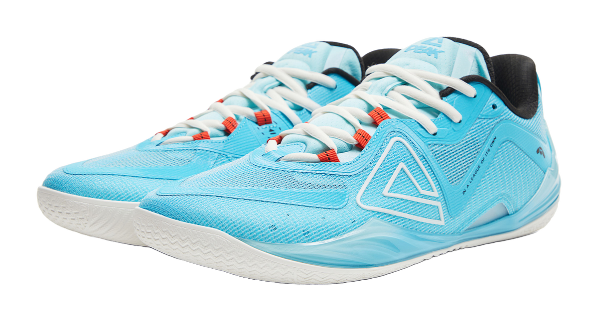 Blue basketball shoe with white laces and red accents on the tongue eyelets