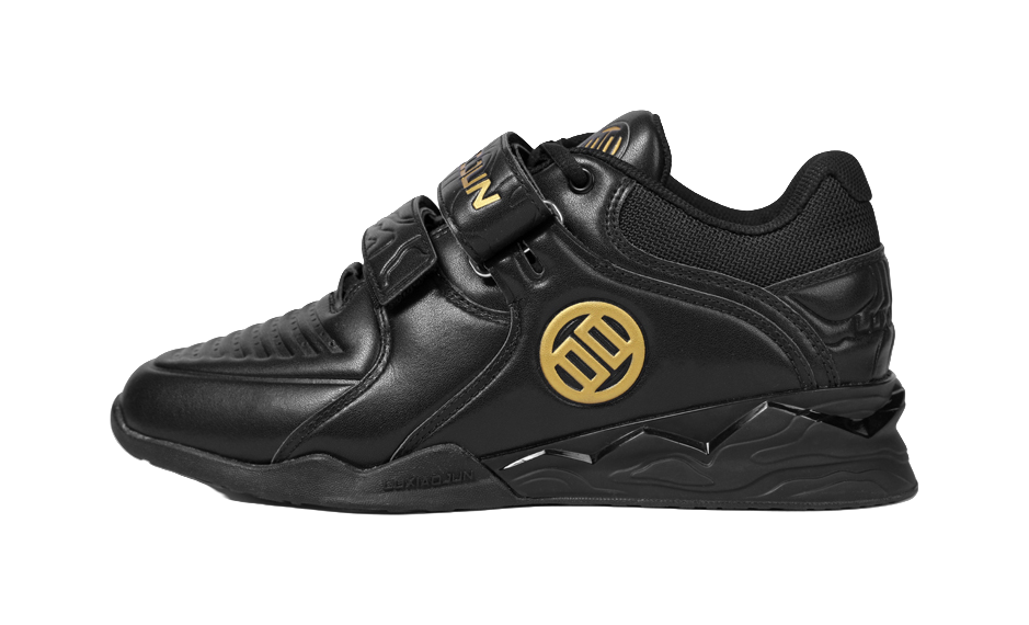 Black low-top training shoes with gold emblem, hook-and-loop strap, sculpted sole