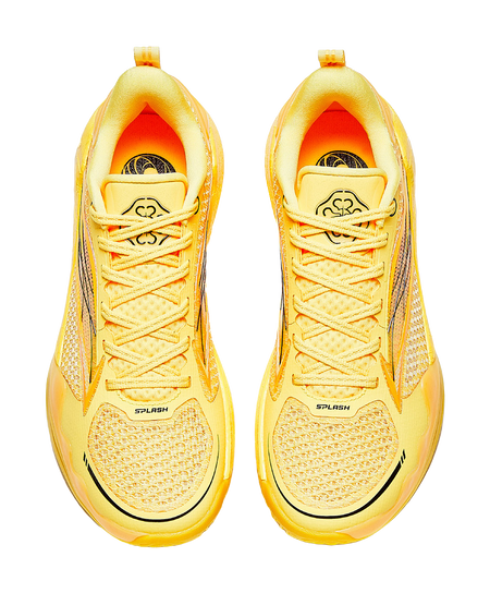 Pair of yellow lace-up basketball shoes with mesh-like texture and cushioned tongue