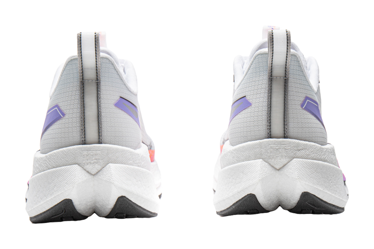 White running shoes back view with purple heel tabs and thick cushioned sole