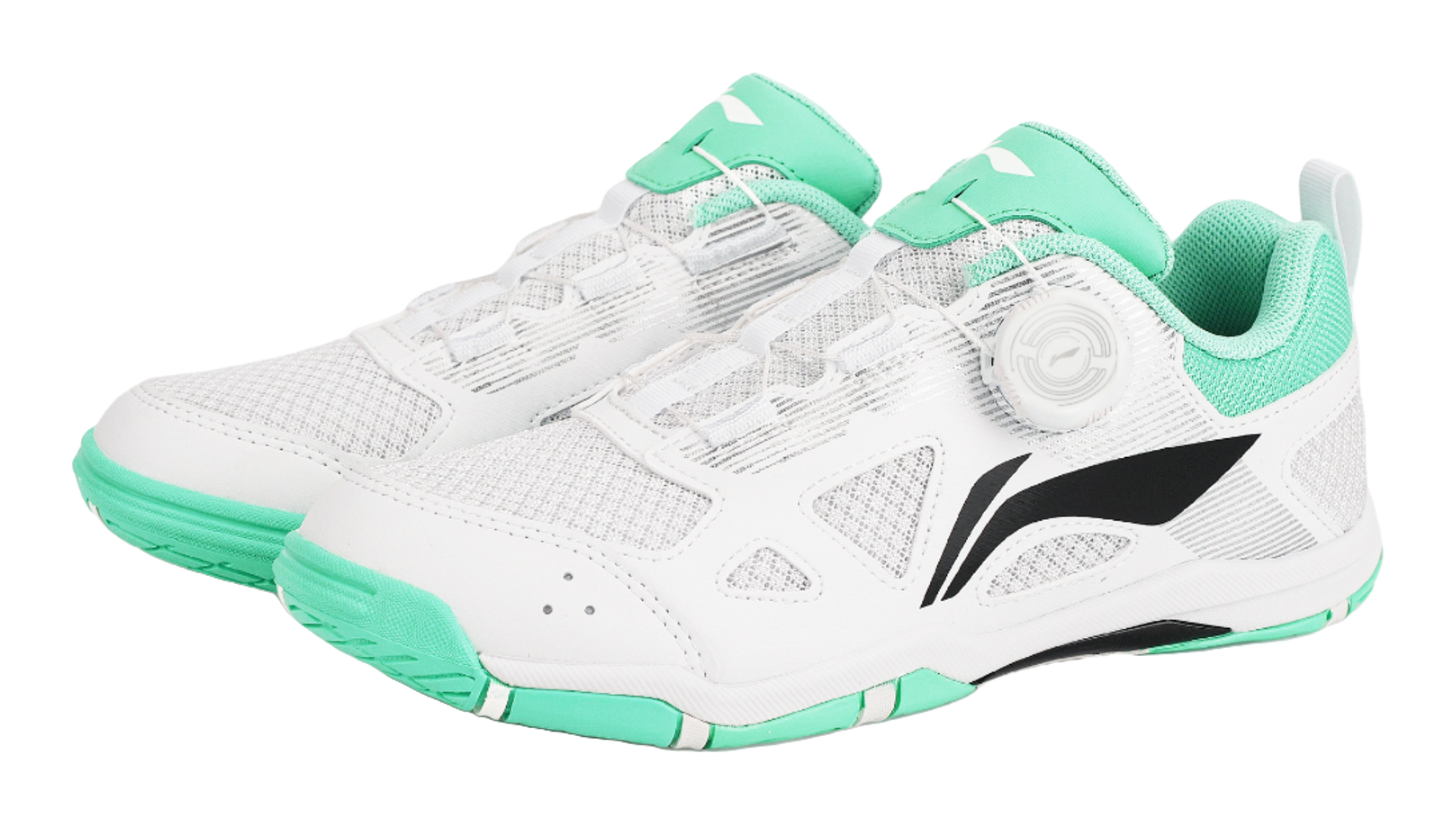 Pair of table tennis shoes in white with green uppers and black side logo