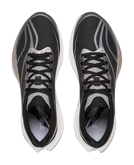 Pair of black lace-up running shoes with gray lining and patterned tongue.