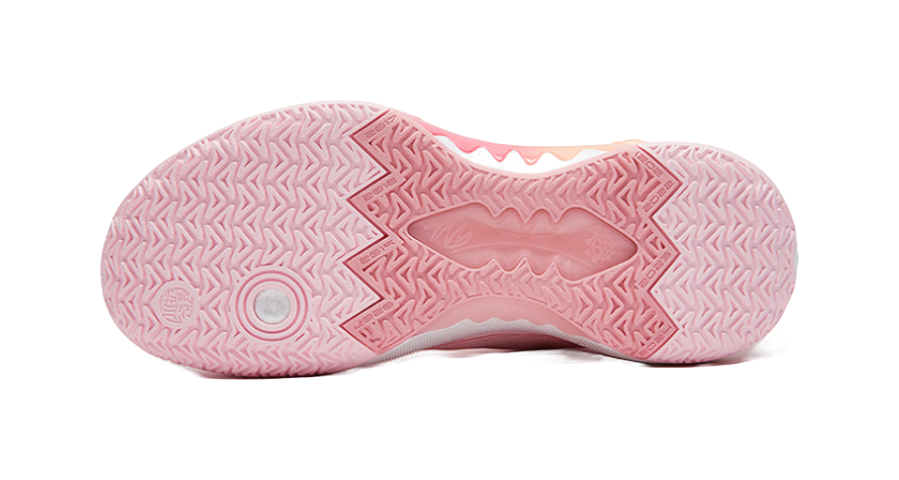 Pink outsole with geometric traction pattern on underside of basketball shoe