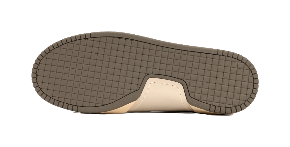 Low-top sneaker outsole with textured grid tread and tan rubber edge