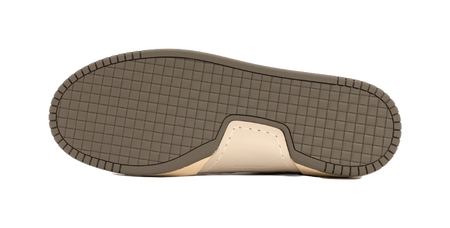Low-top sneaker outsole with textured grid tread and tan rubber edge