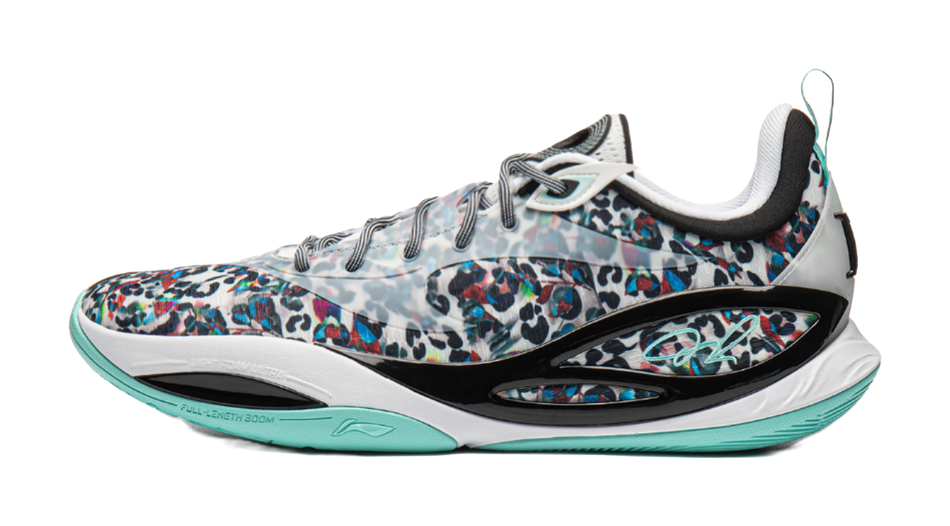 White and black low-top basketball shoe with multicolor leopard print upper and teal sole