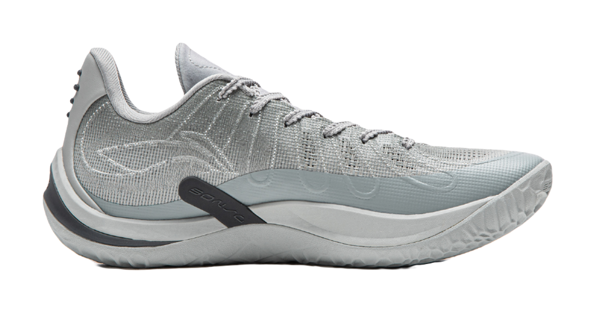 Gray basketball shoe side view with teal accent midsole
