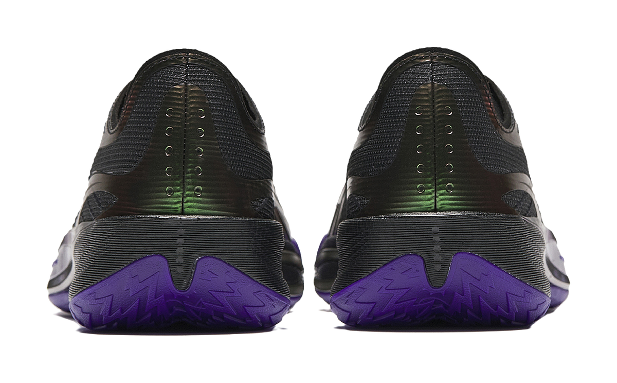 Pair of black basketball shoes with purple heel tread and neon green branding
