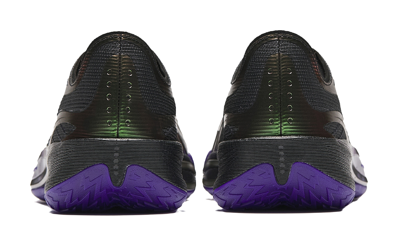 Pair of black basketball shoes with purple heel tread and neon green branding