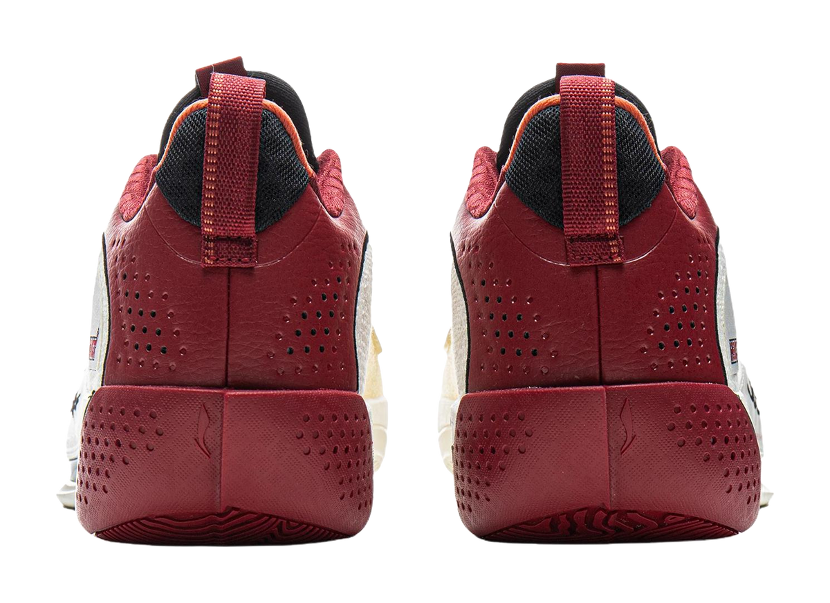 Pair of red basketball shoes with perforated sides, black heel collar, and lace-up strap
