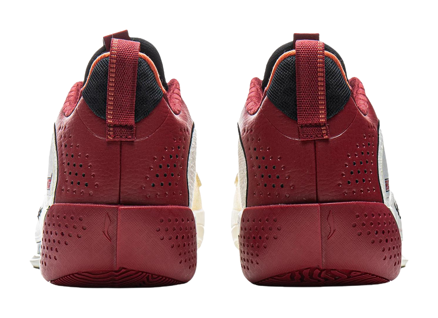 Pair of red basketball shoes with perforated sides, black heel collar, and lace-up strap