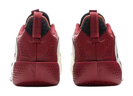 Pair of red basketball shoes with perforated sides, black heel collar, and lace-up strap