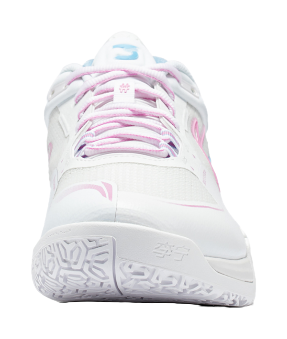 White badminton shoe front with pink laces, padded tongue, and mesh-like upper texture