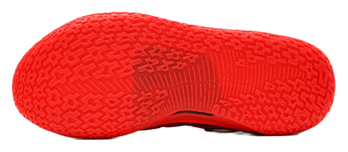 Red basketball shoe outsole with multidirectional traction pattern
