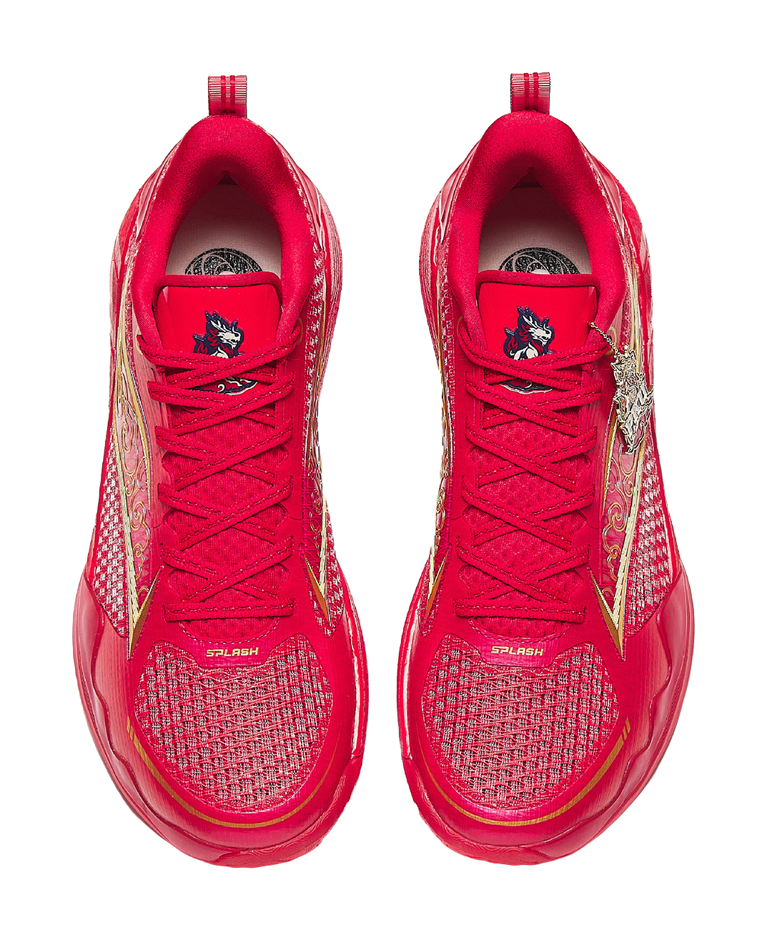Pair of red basketball shoes with red laces, textured uppers, and gold side panels.
