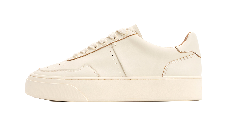 Antique white low-top skate shoes with lace-up closure and stitched paneling