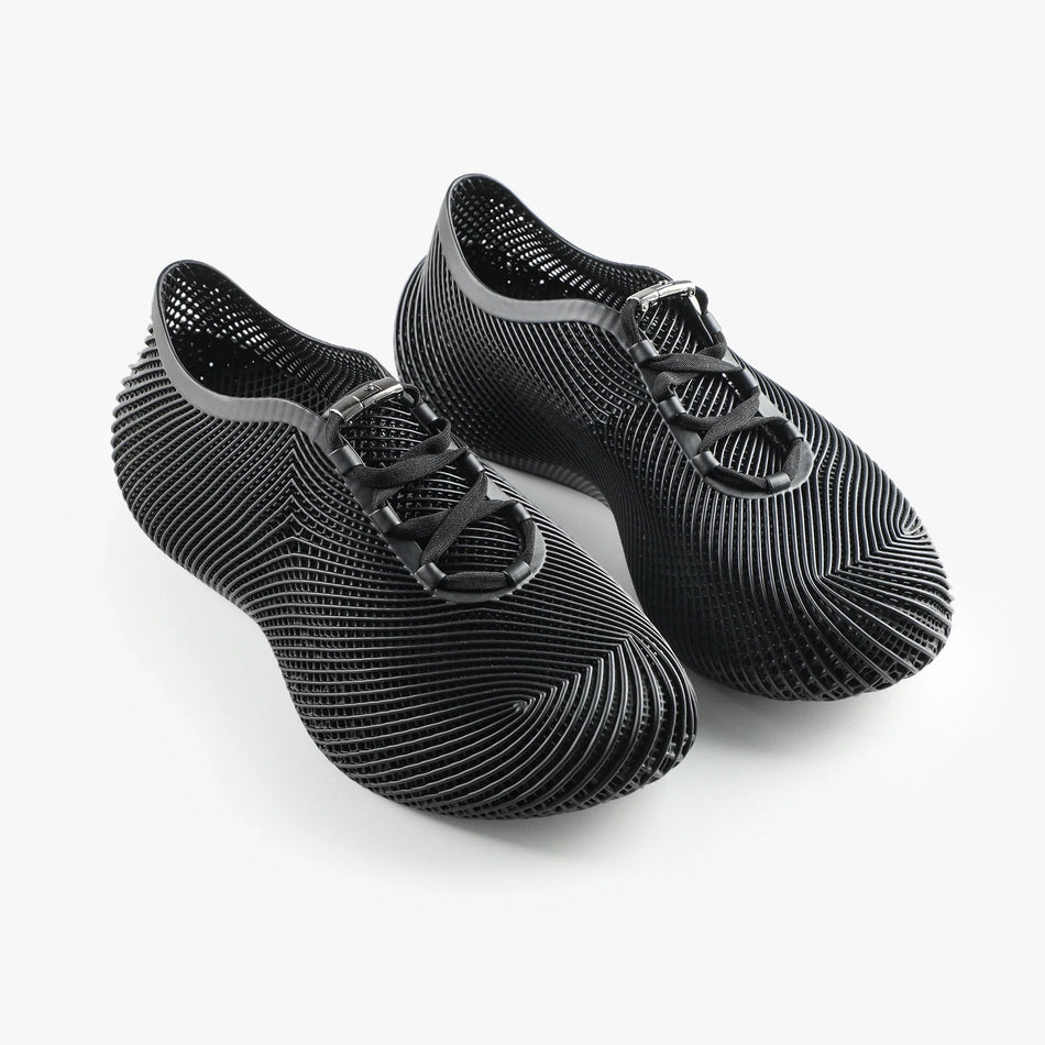 Black 3D-printed sneakers with lace-up and hook strap, textured side and rounded toe