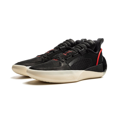 Men's black basketball shoes with red trim, lace-up design, chunky light sole.