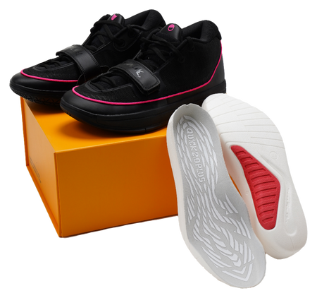 Black lace-up basketball shoes with pink trim and white-and-red outsole view