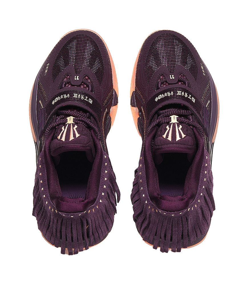 Purple basketball shoe heel and tongue detail, lace loops and patterned fabric upper