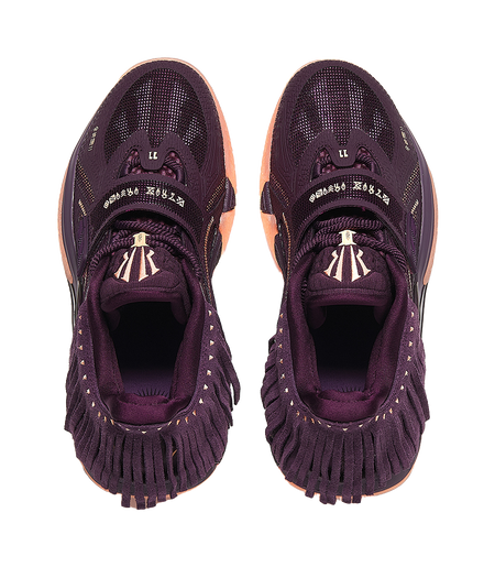 Purple basketball shoe heel and tongue detail, lace loops and patterned fabric upper
