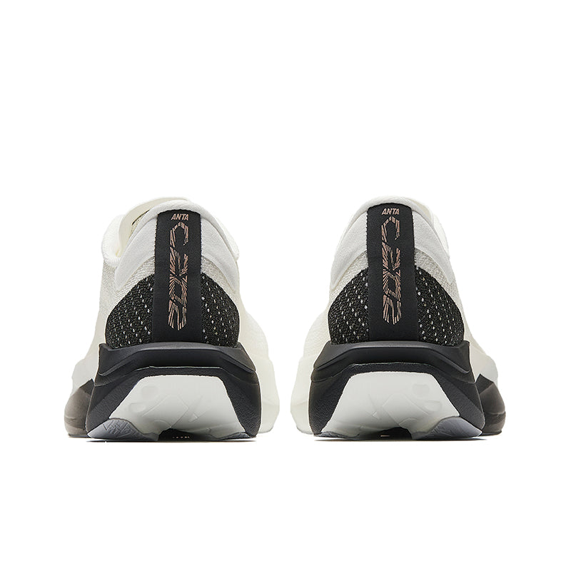 Pair of white running shoes with black heel counter, cushioned back tabs, and sole