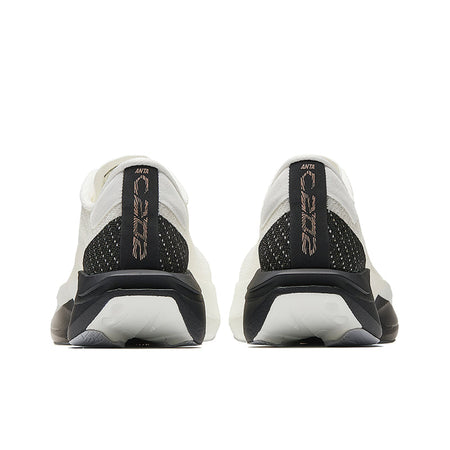 Pair of white running shoes with black heel counter, cushioned back tabs, and sole