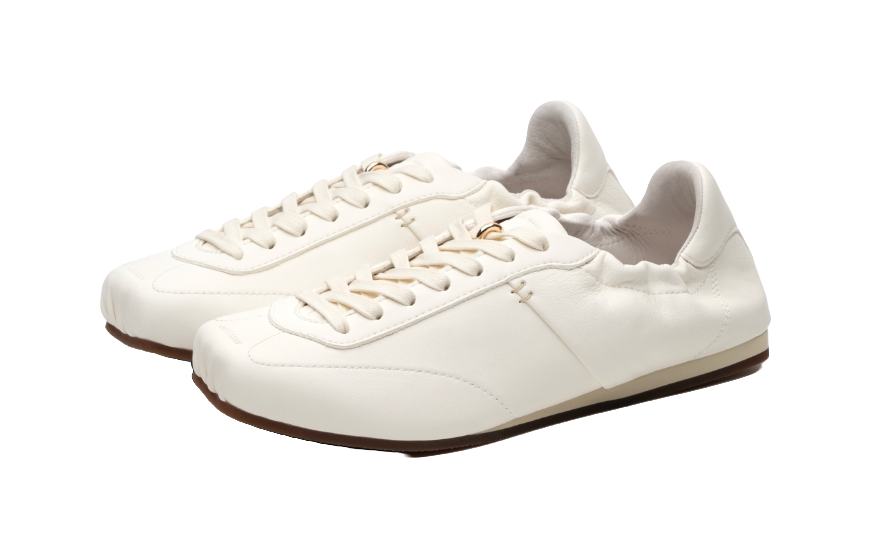Antique white low-top trainers, angled view showing lace-up top and thin sole