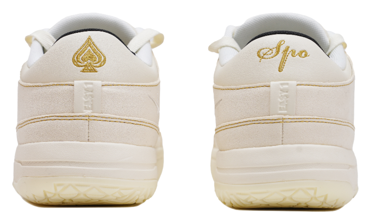 Cream sneaker heels with gold Spade logo and padded back tabs