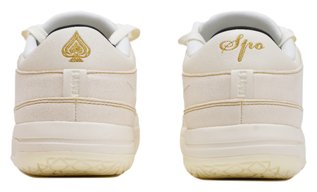 Cream sneaker heels with gold Spade logo and padded back tabs