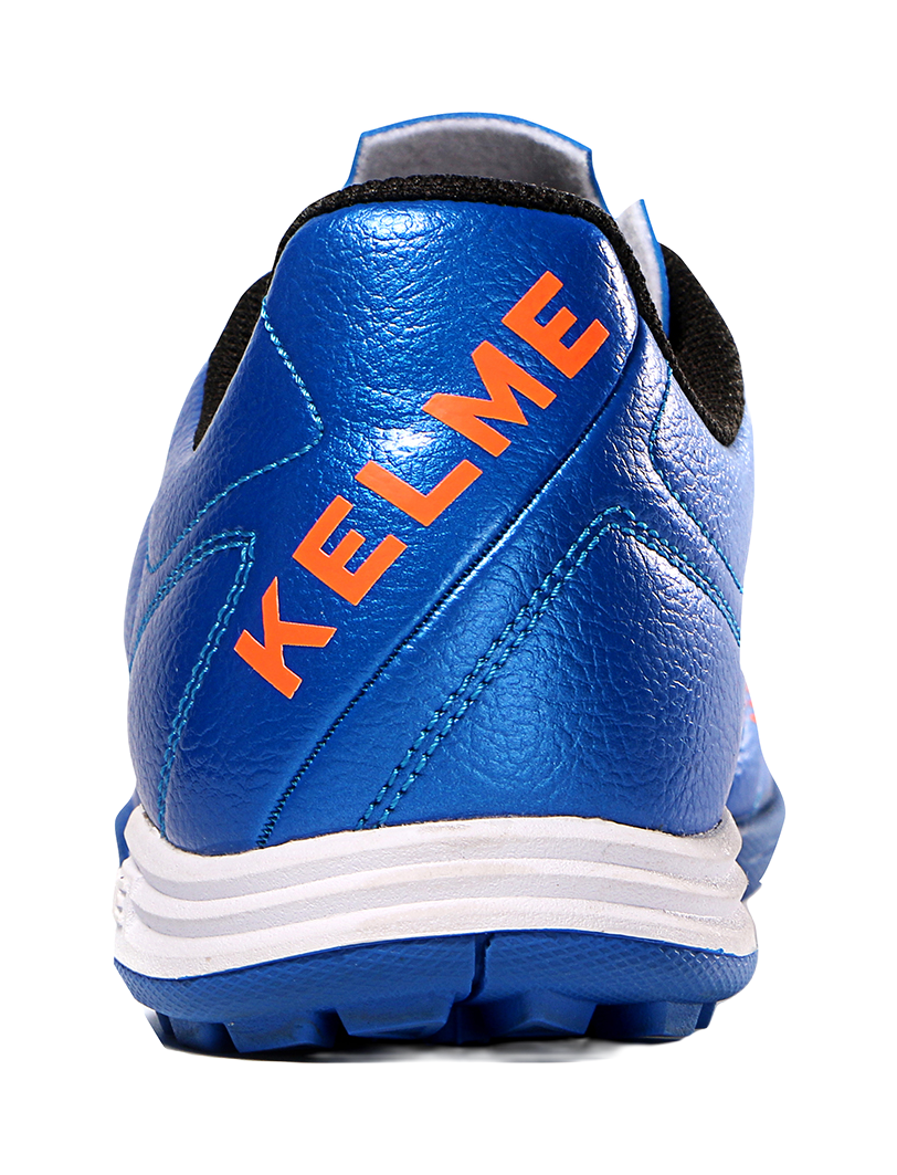Kelme royal blue soccer shoe heel with orange KELME lettering and padded collar