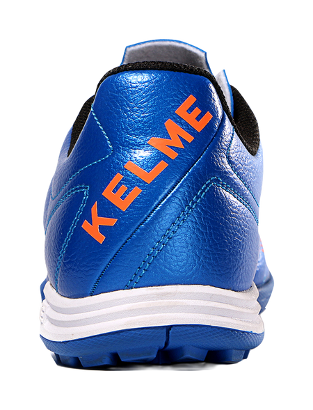 Kelme royal blue soccer shoe heel with orange KELME lettering and padded collar