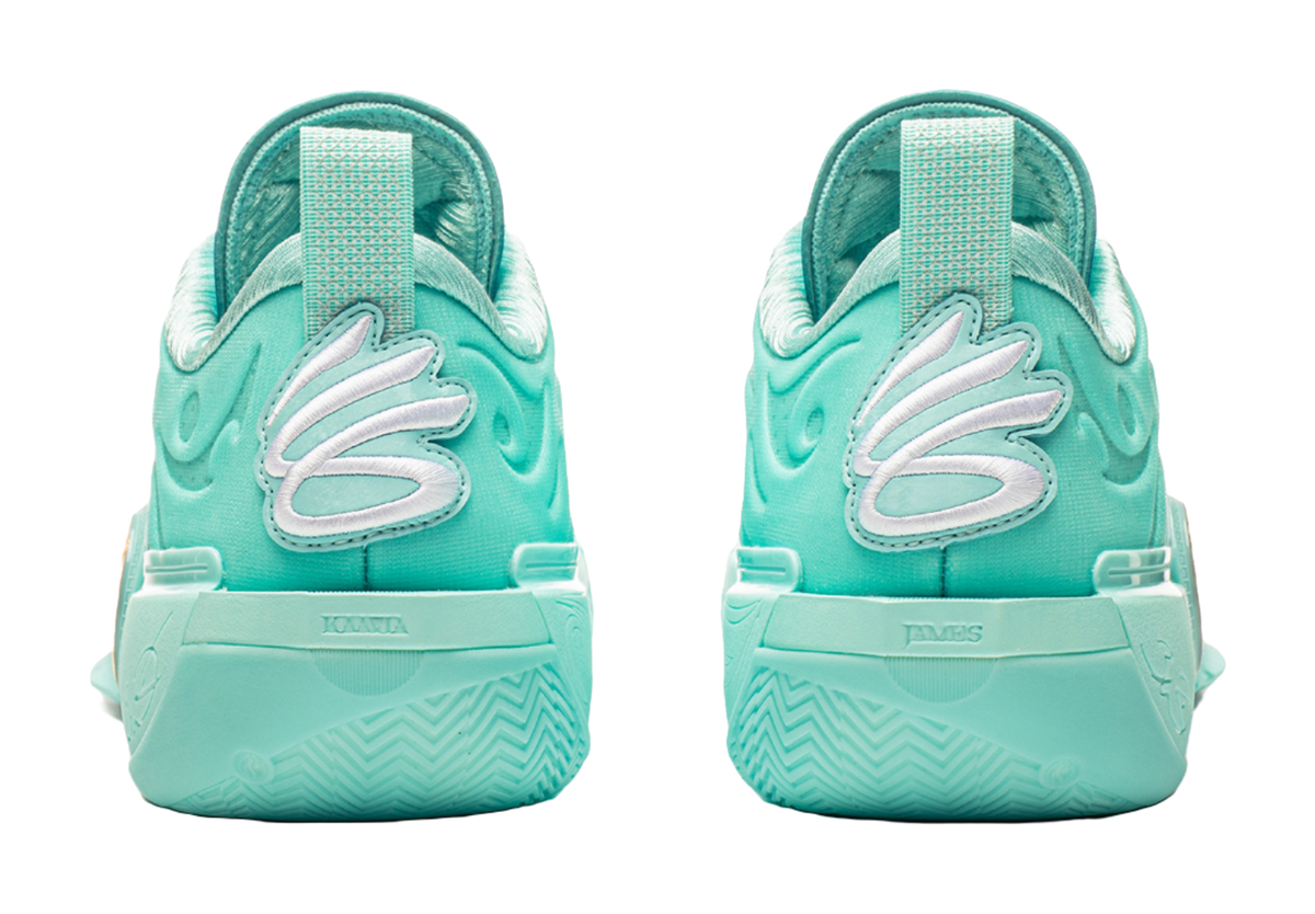 Light teal low-top basketball shoes, heel view with embossed logo and cushioned collar