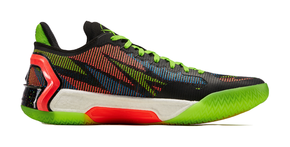 Black basketball shoe with multicolor mesh upper, neon green sole, and red heel