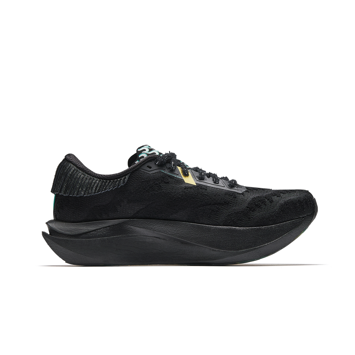 Women’s black running shoe side view with green accent stripe and sculpted sole.